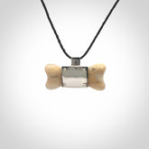 This is a hand carved deer antler dog bone dog tag. It is made from deer antler, bone and sterling silver. Hand made dog tags for your dog.